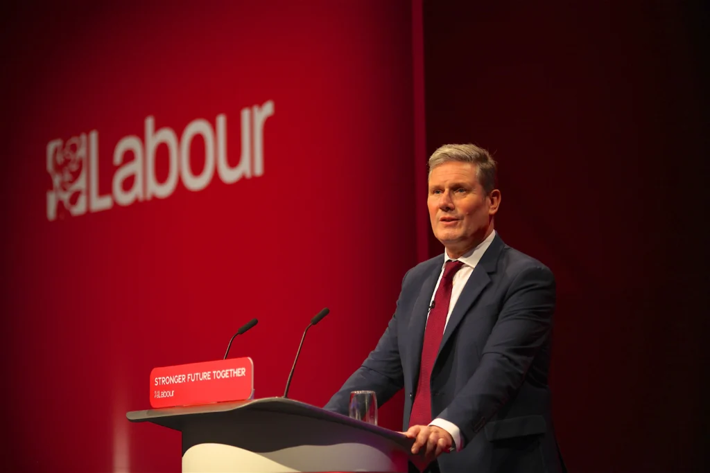 Keir Starmer speaking at a conference with stronger future together written on the podium